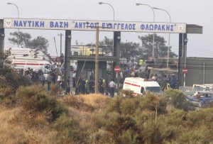 Emergency personnel are seen at the entrance of a military base where a large explosion occurred in southern Cyprus
