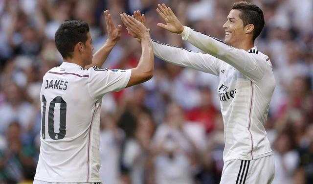 Real Madrid's Ronaldo celebrates with Rodriguez after scoring with a penalty kick against Barcelona during their Spanish first division "Clasico" soccer match at the Santiago Bernabeu stadium in Madrid