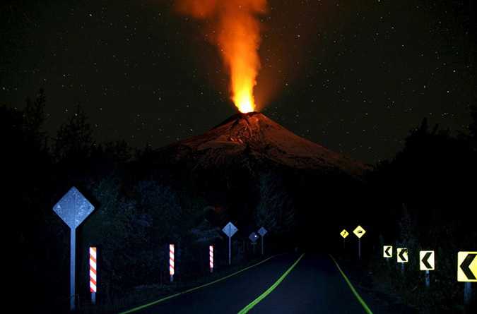 Smoke and lava spew from the Villarrica volcano, as seen from Pucon town, in the south of Santiago, April 22, 2015. Authorities have restricted access to the area within 5 kilometres (3 miles) of the crater and have put the area under an orange alert due to the volcano's heightened unrest and increased likelihood of eruption. REUTERS/Cristobal Saavedra TPX IMAGES OF THE DAY